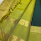 Deep forest-green Kanchipuram silk body showing sparse silver-toned maanga and leaf-style woven buttas.
