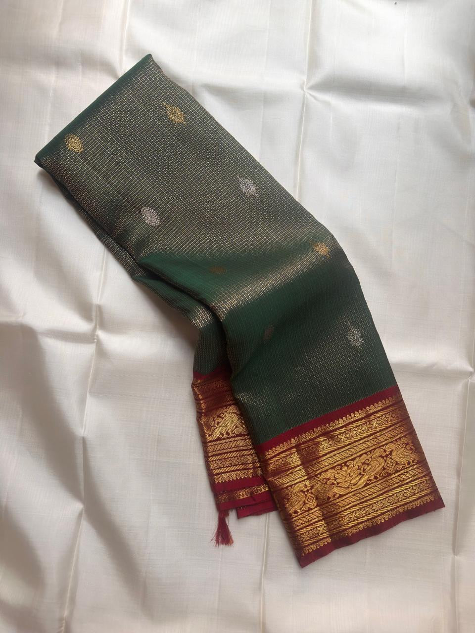 Adar Pachai Kanchipuram saree with fine Zari Kattam body and Arakku gold-zari border.