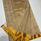 Close view of the gold floral pallu on the Sandalwood Beige Katan Silk Chanderi saree.