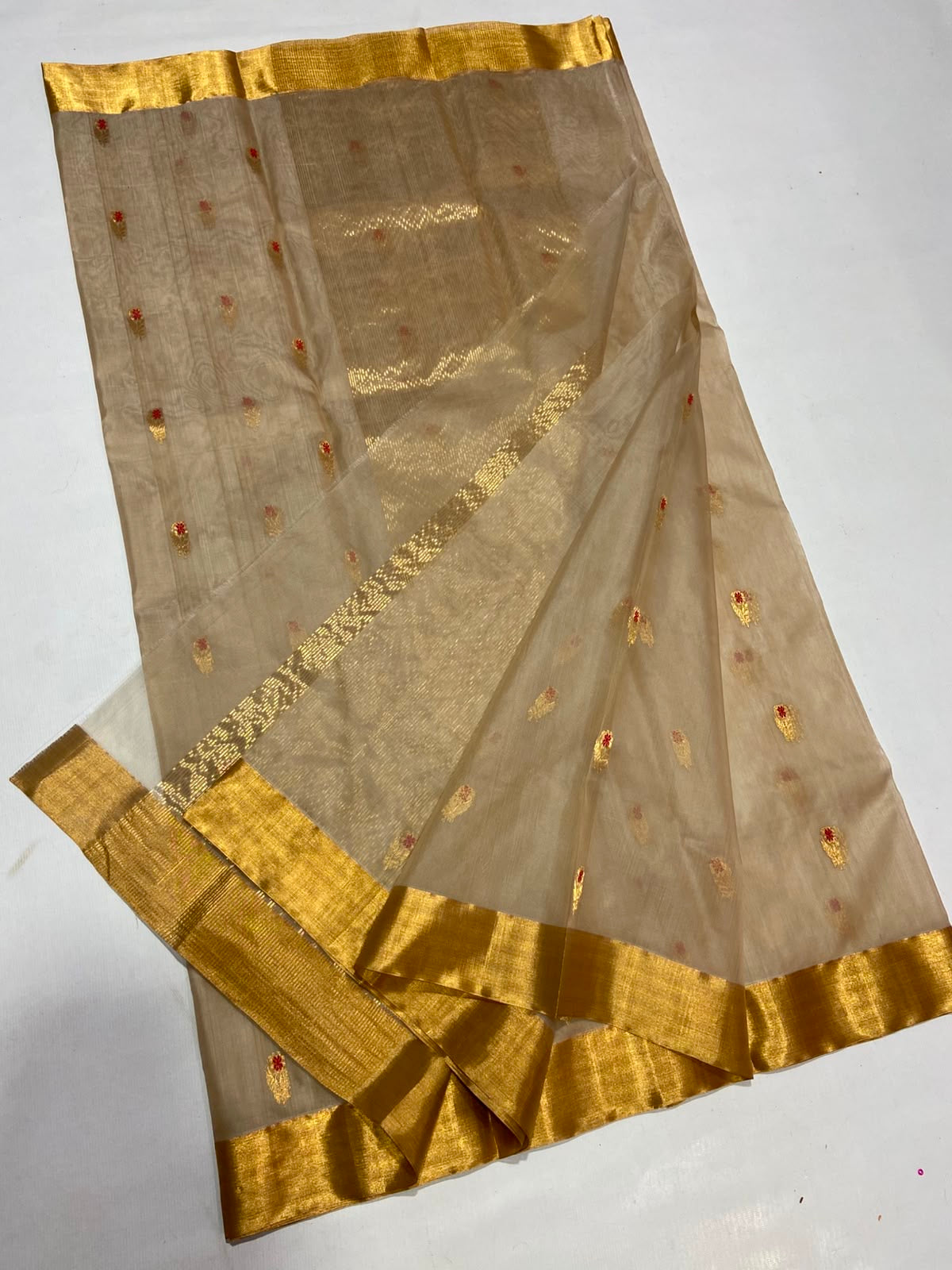 Close view of the gold floral pallu on the Sandalwood Beige Katan Silk Chanderi saree.