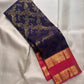 Aubergine-purple Kanchipuram silk body richly woven with continuous floral and leafy classic gold zari brocade.
