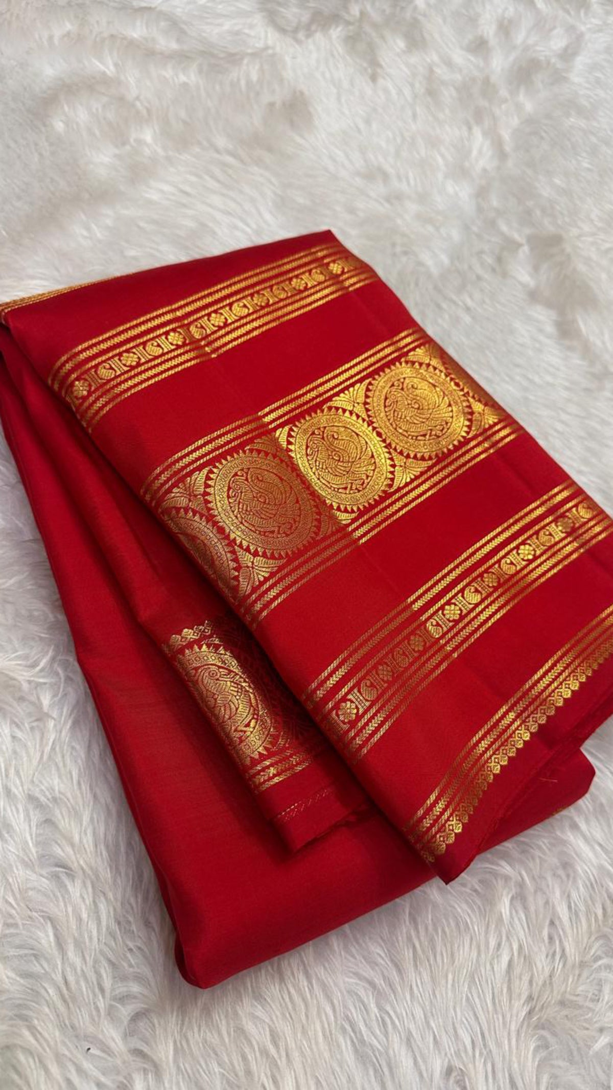 Deep Vermilion Red pure silk Kanchipuram Varisaipet saree, full saree folded for display.