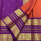 Pure silk Kanchipuram saree with purple body, rust-orange contrast and gold zari.