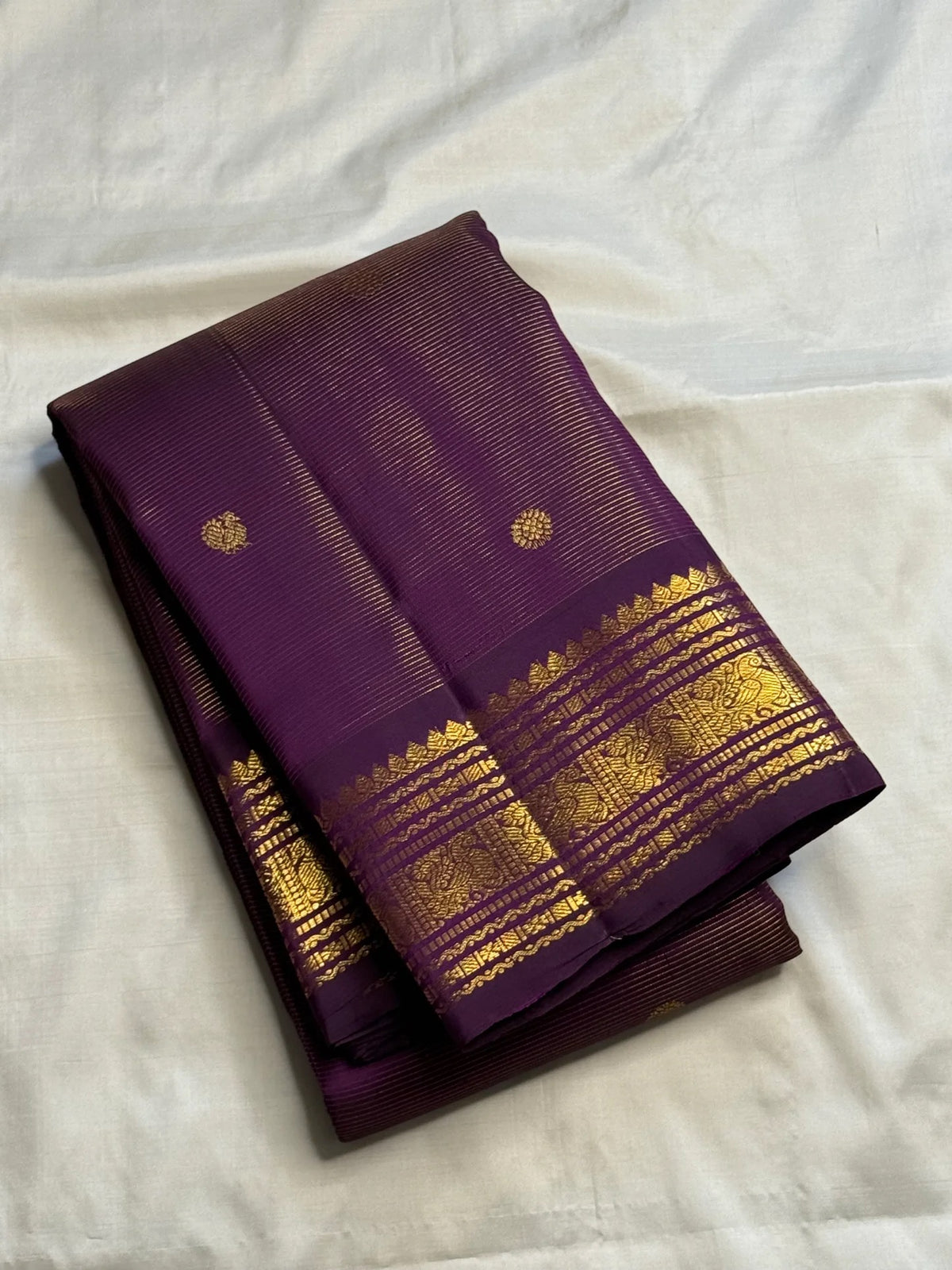 Close-up of the gold zari border on the Kathiripoo purple Kanjivaram silk saree