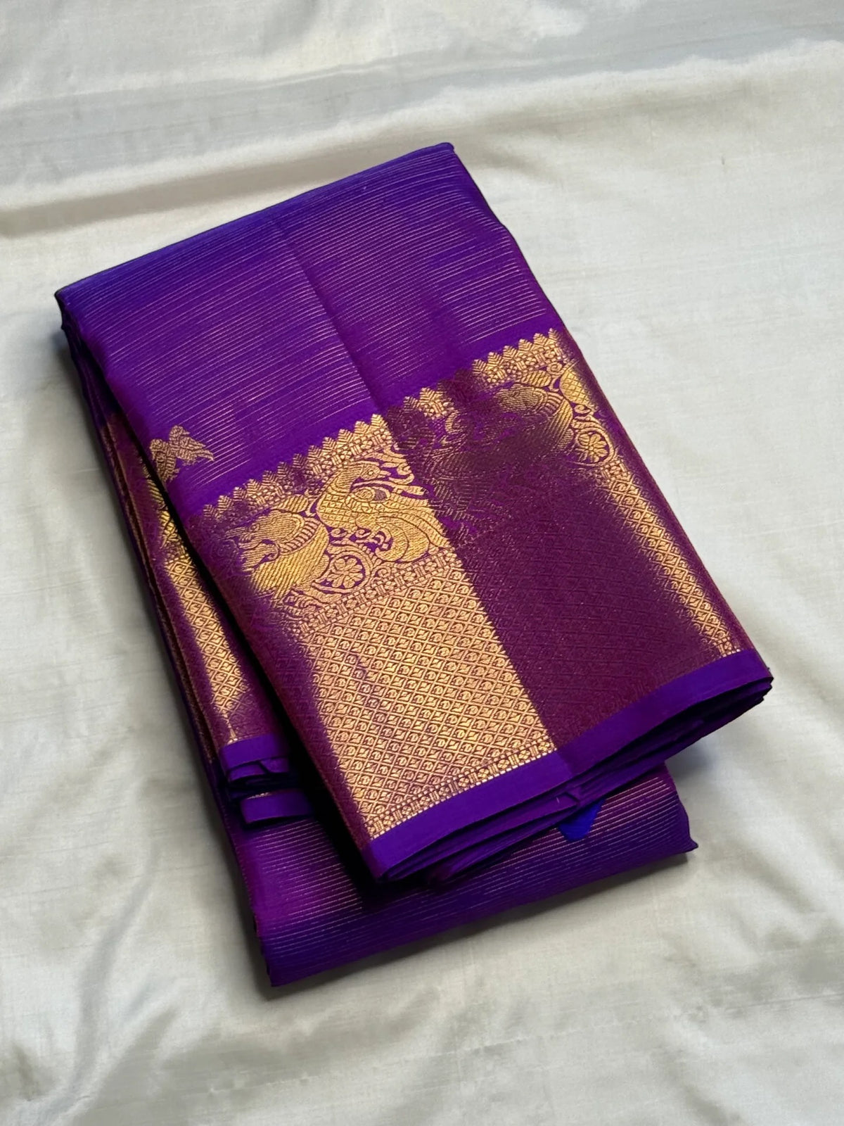 Purple Kanchipuram Vairaoosi silk saree with fine continuous parallel gold zari lines.