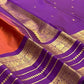 Purple and rust-orange Kanchipuram silk saree with small spaced gold zari buttas.