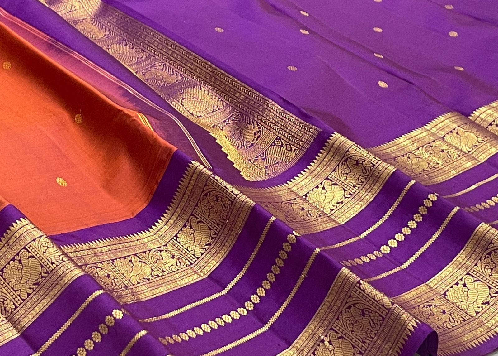 Purple and rust-orange Kanchipuram silk saree with small spaced gold zari buttas.