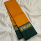 Handwoven saffron gold Kanchipuram silk saree with deep green contrast Korvai border and zari detailing