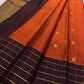 Gold-rich dark brown pallu with densely repeated circular motifs and fine gold checked outer section