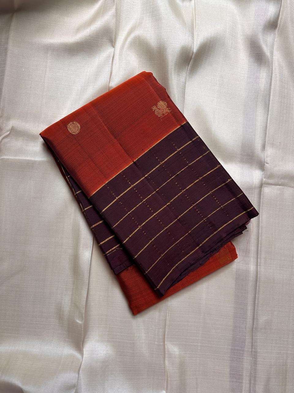 Kesari orange pure silk body with spaced small gold buttas and broad checked kaapi brown border