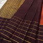 Small spaced golden motifs woven across the vivid terracotta-orange Kanchipuram silk body