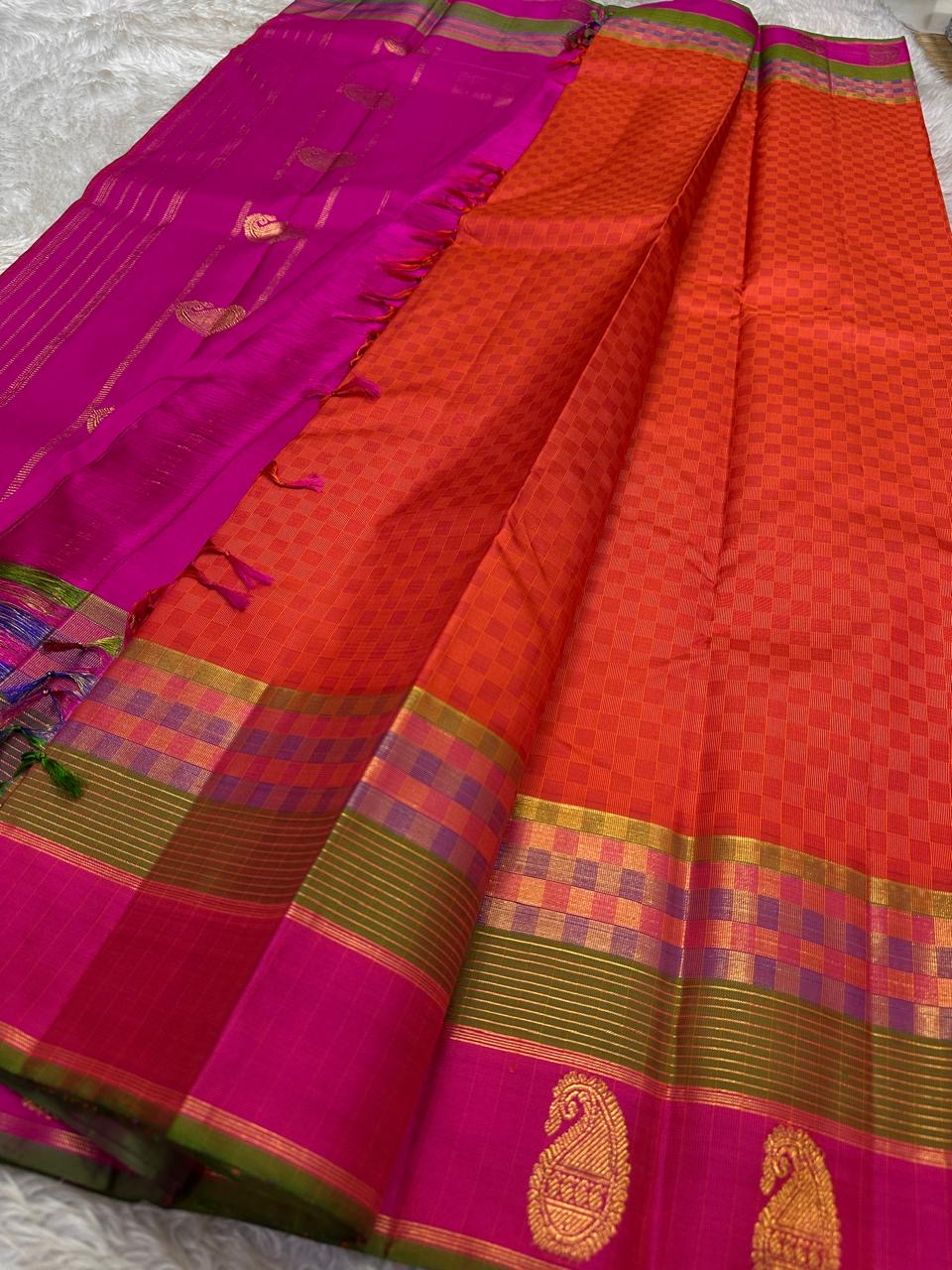 Kesari-orange Pure Silk Kanjivaram Butta saree with paimadi kattam body and colourful Vadamalli border.
