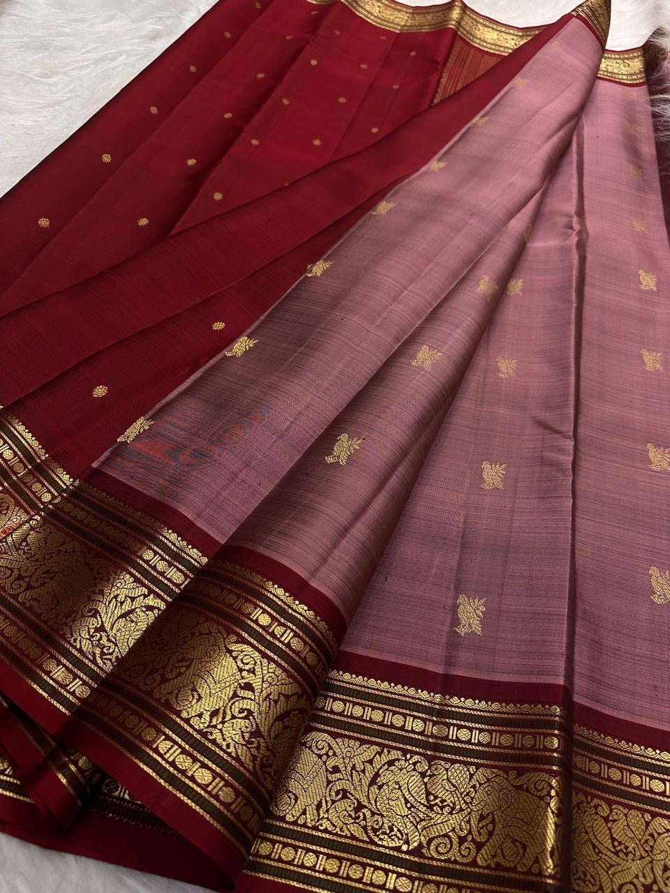 Close-up of Kili Butta antique gold zari motifs on Kanjipuram silk saree