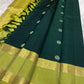 Close view of the luminous Kili Pachai Rettapet with large Chakram medallions woven in classic gold zari.