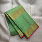 Kili Pachai green border with floral-vine and geometric gold-zari registers along the silk edge.