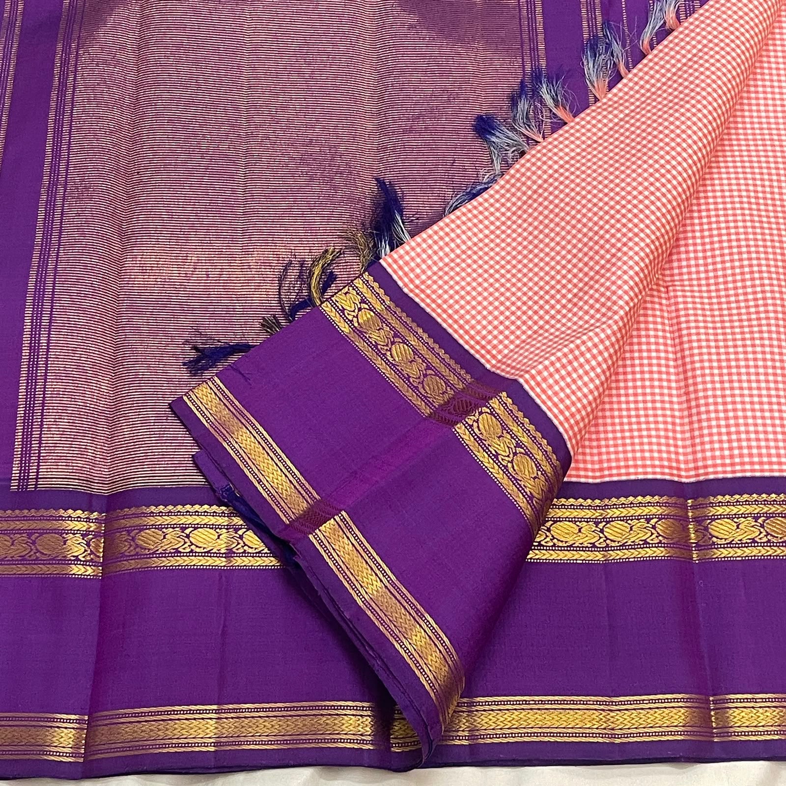 Royal purple zari pallu detail on the rose pink Kanchi Pattu saree, with kasu motifs.