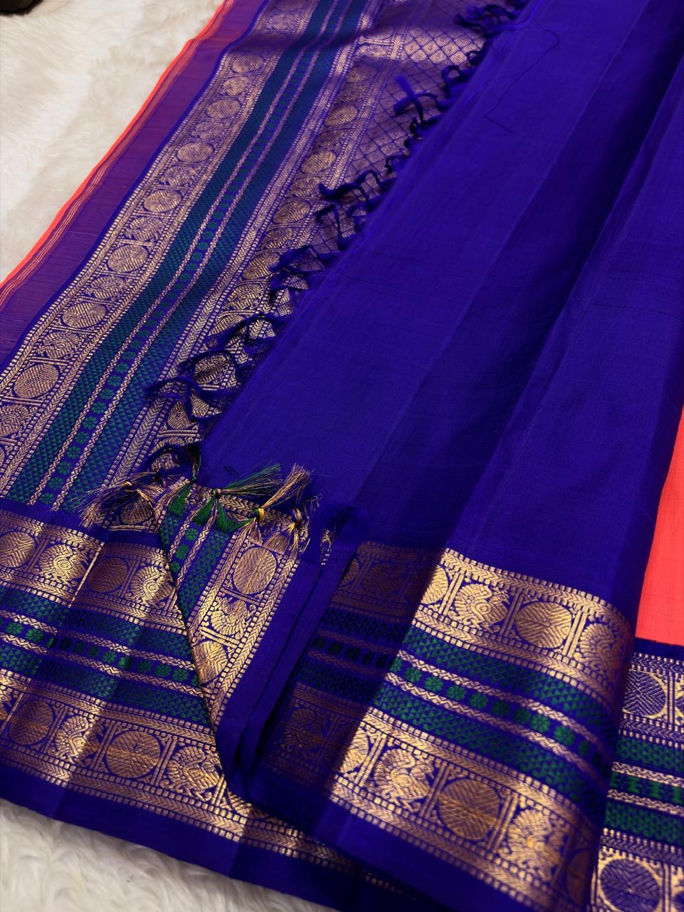 Korvai Kanchipuram saree coral sunset orange with royal violet border – pallu detail