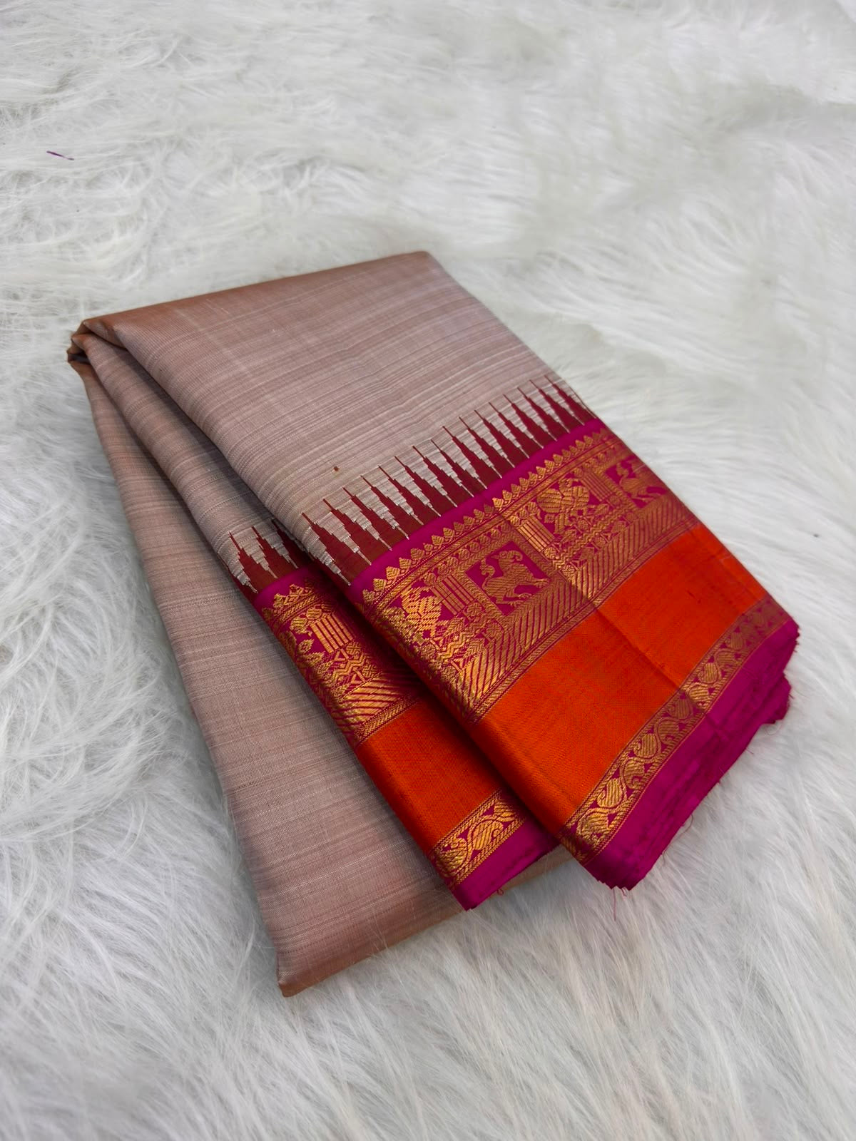 Magenta and orange Pillayar Reku border on Warm Beige Kanchipuram Korvai silk saree