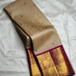 Reverse view showing the underside of the pallu and the contrast between the beige body and magenta border