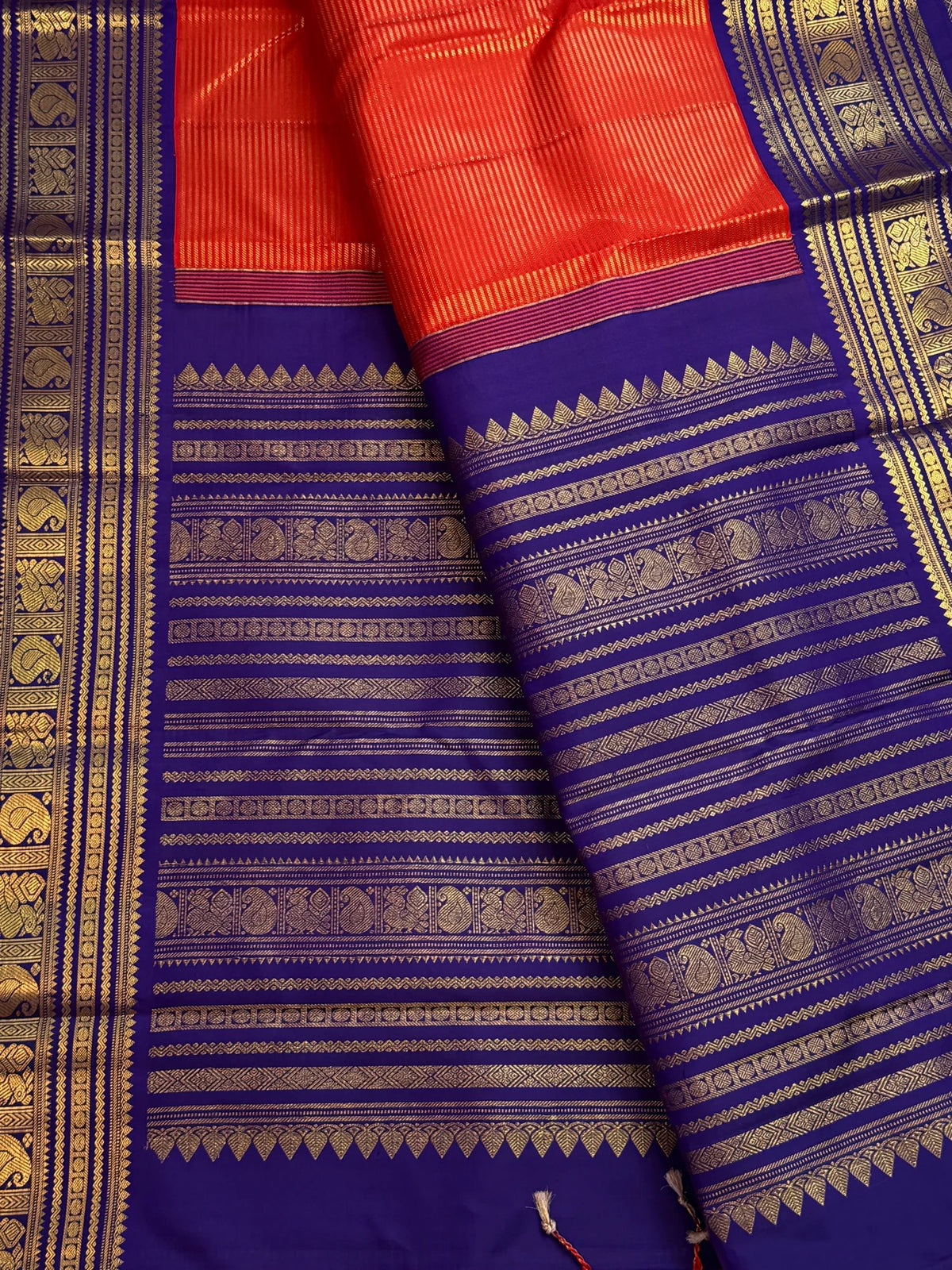 Close-up of Vairaoosi zari detail on kungumapoo orange Kanchipuram pure silk saree
