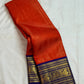 Kungumapoo orange Kanjivaram silk saree with royal blue border and pallu