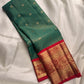 Kumkum red contrast border with broad gold zari bands.