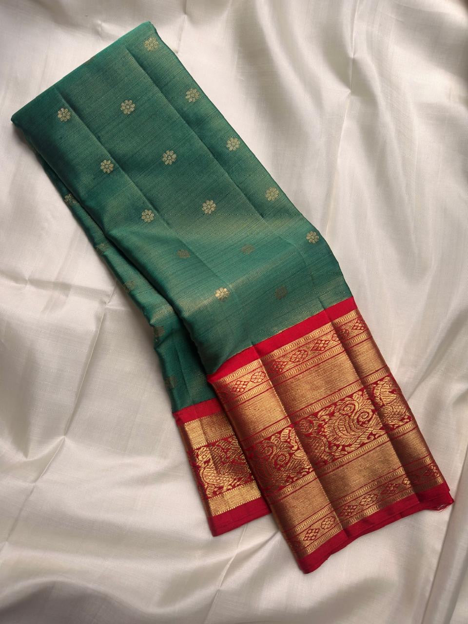 Kumkum red contrast border with broad gold zari bands.
