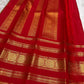 Kumkum red Kancheepuram Rettapet silk saree with gold zari border, folded view.