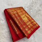 Kanchipattu silk saree in vibrant kumkum red with antique gold border Vanasringaram weave traditional zari detail