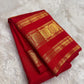 Kumkum red Kanjivaram pure silk saree showing the zari medallion border detail.
