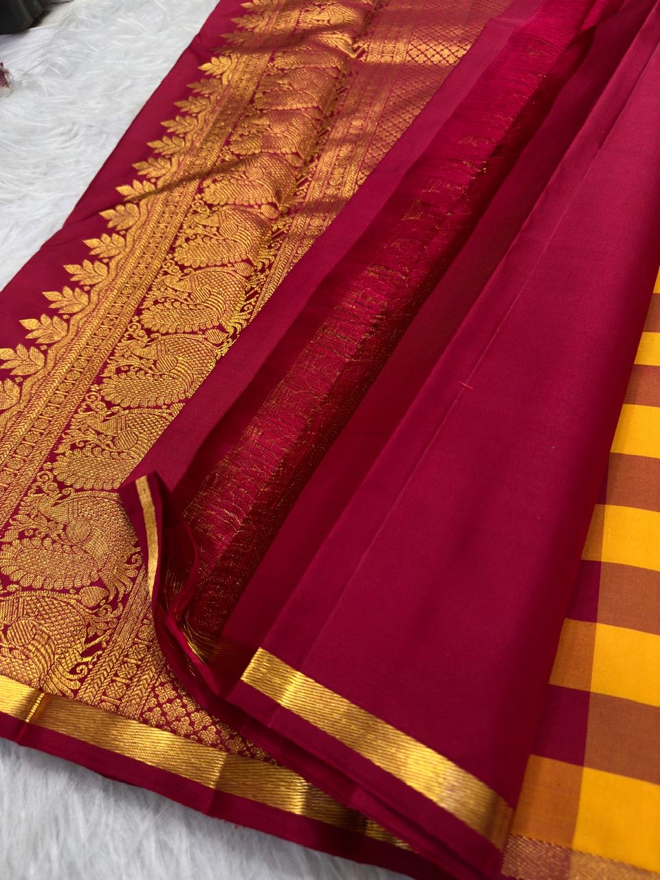 Bold red and yellow checked Kanchipuram body with spaced ornate gold zari buttas