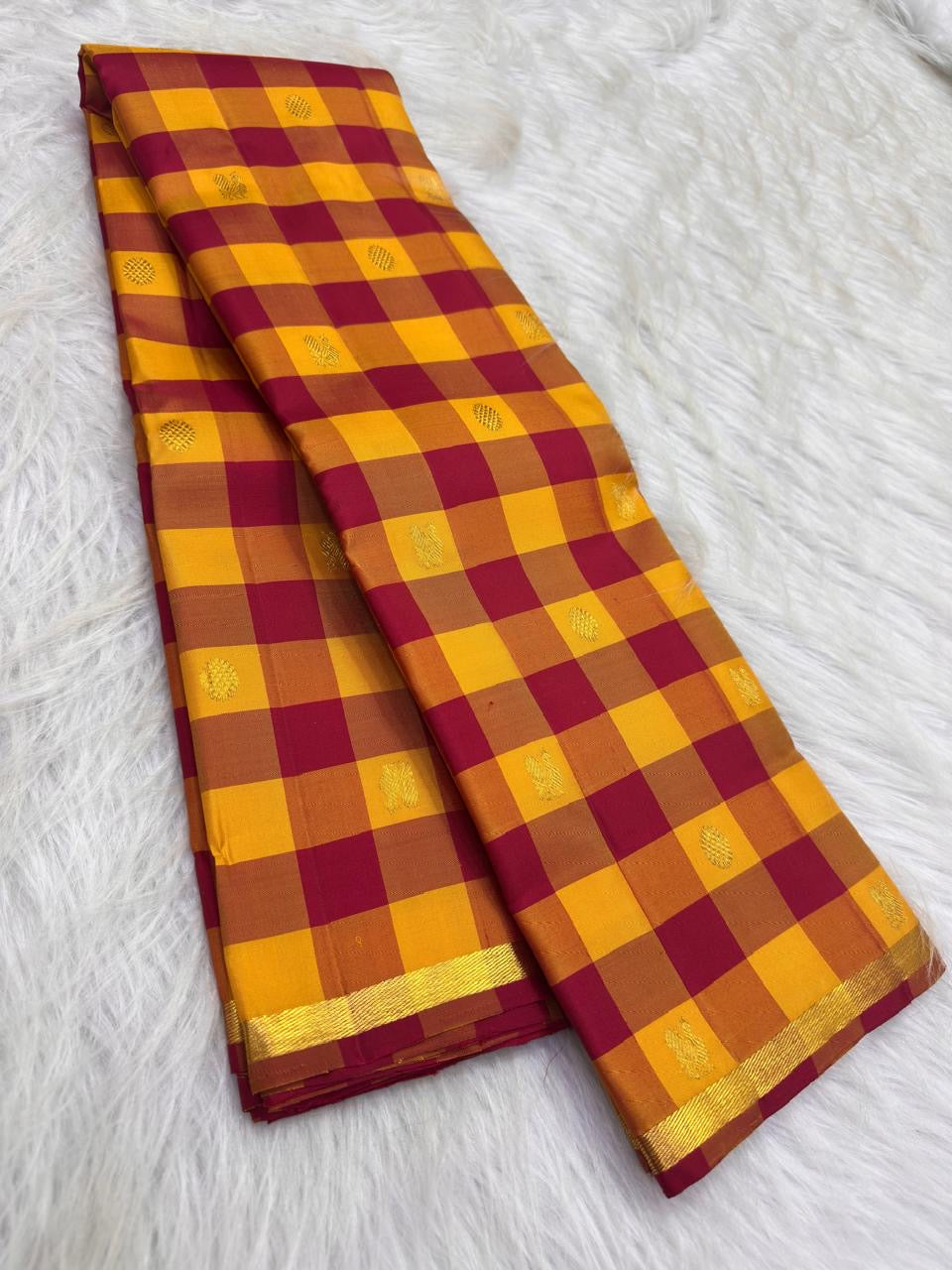 Close view of handwoven checked silk body with small ornate zari motifs