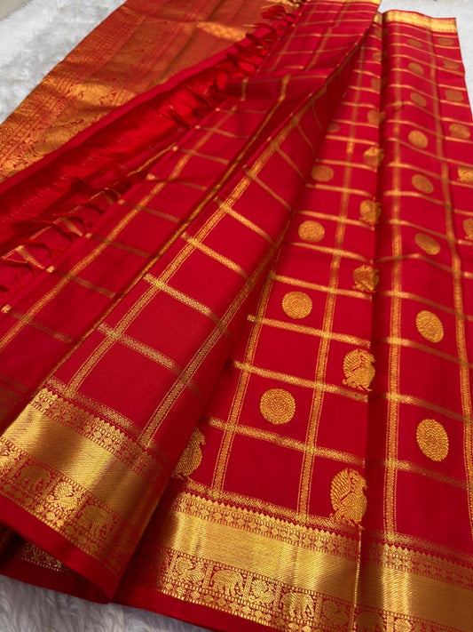 Kumkumam Red Pure Silk Kanchipuram with generous gold Zari Kattam compartments.