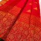 Narrow bottle-green selvedge finishing the rich red and gold Kanchi Pattu border.