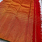Kumkumam Red handwoven Pure Silk Kanchipuram Butta saree with a broad gold floral zari border and bottle-green edging.