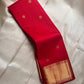 Pure silk Kanchivaram saree with delicate zari buttas woven across a vibrant red body