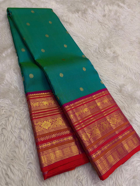 Kanchipattu silk saree in peacock teal with rani pink border Korvai Varisaipet weave traditional zari detail