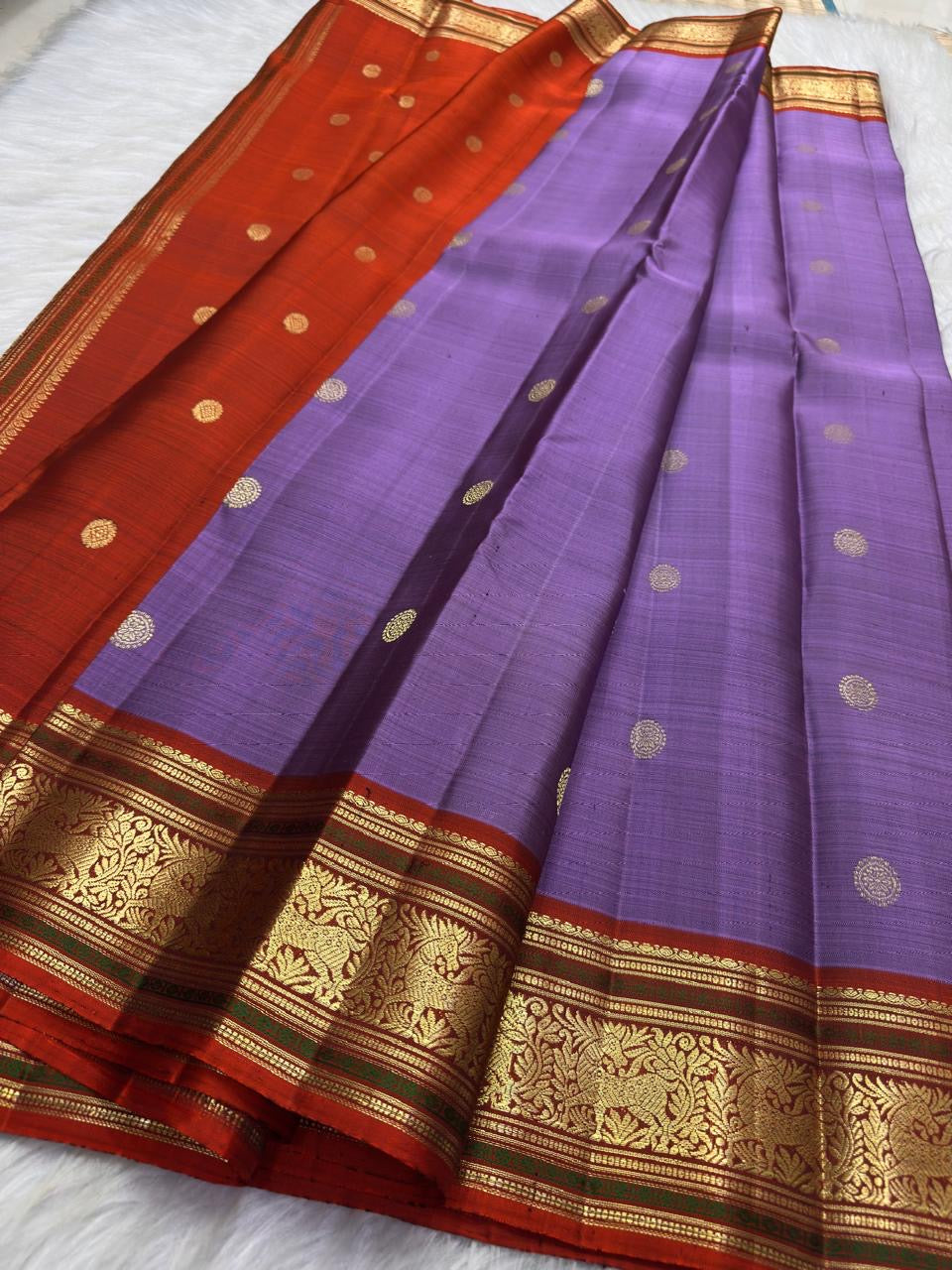 Close border detail showing classic-gold floral scrollwork against the warm Rust-Arakku contrast silk.
