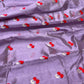 Close-up of bright red paired floral motifs with silver-toned leaves on lavender Chanderi silk