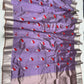 Delicate silver leaf motifs beside red flowers on purple silk