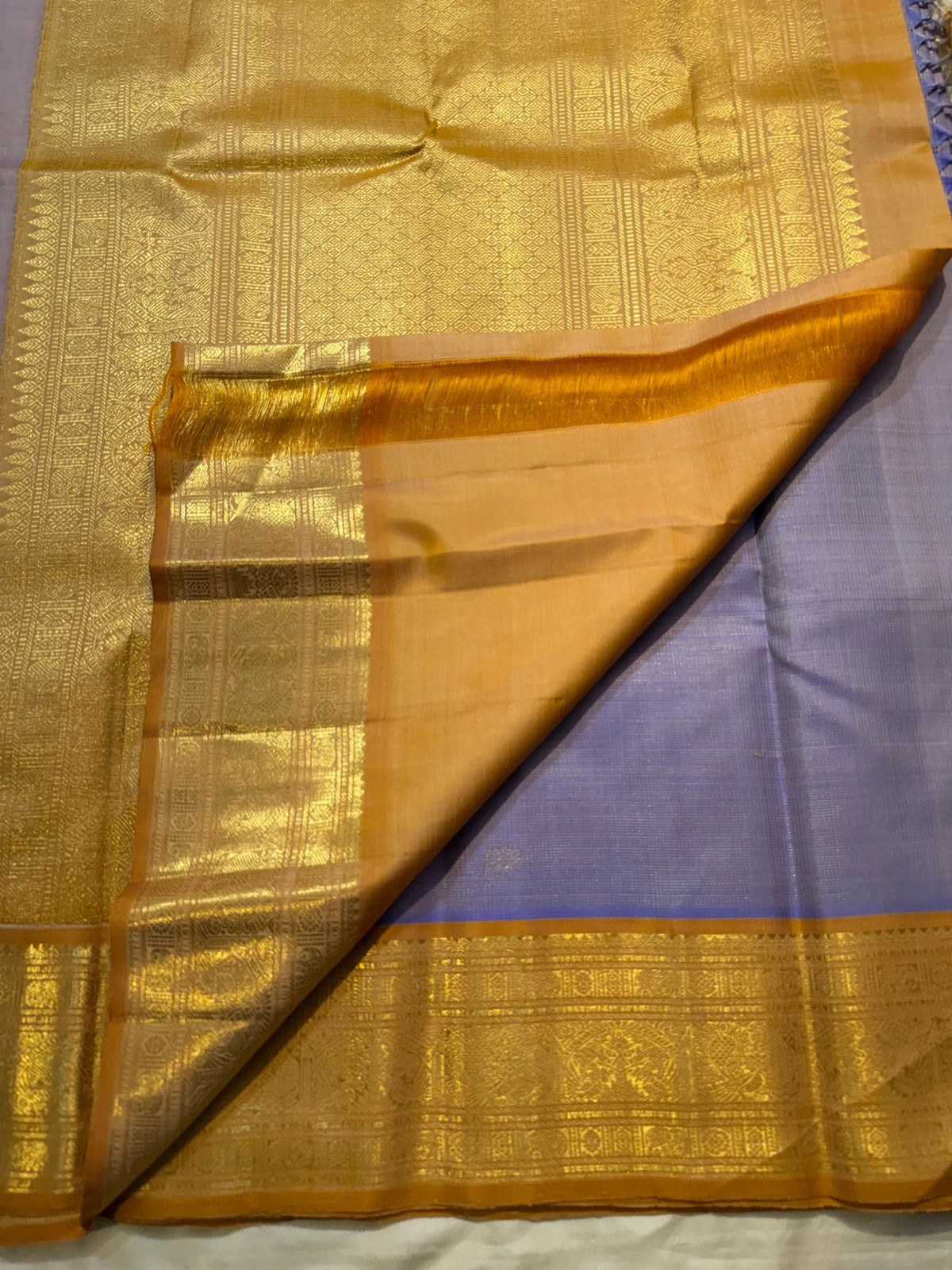 Close-up of the gold zari border on the lavender Kanchi Pattu saree
