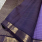 Deep plum pallu close-up with zari woven floral border and solid contrast panel