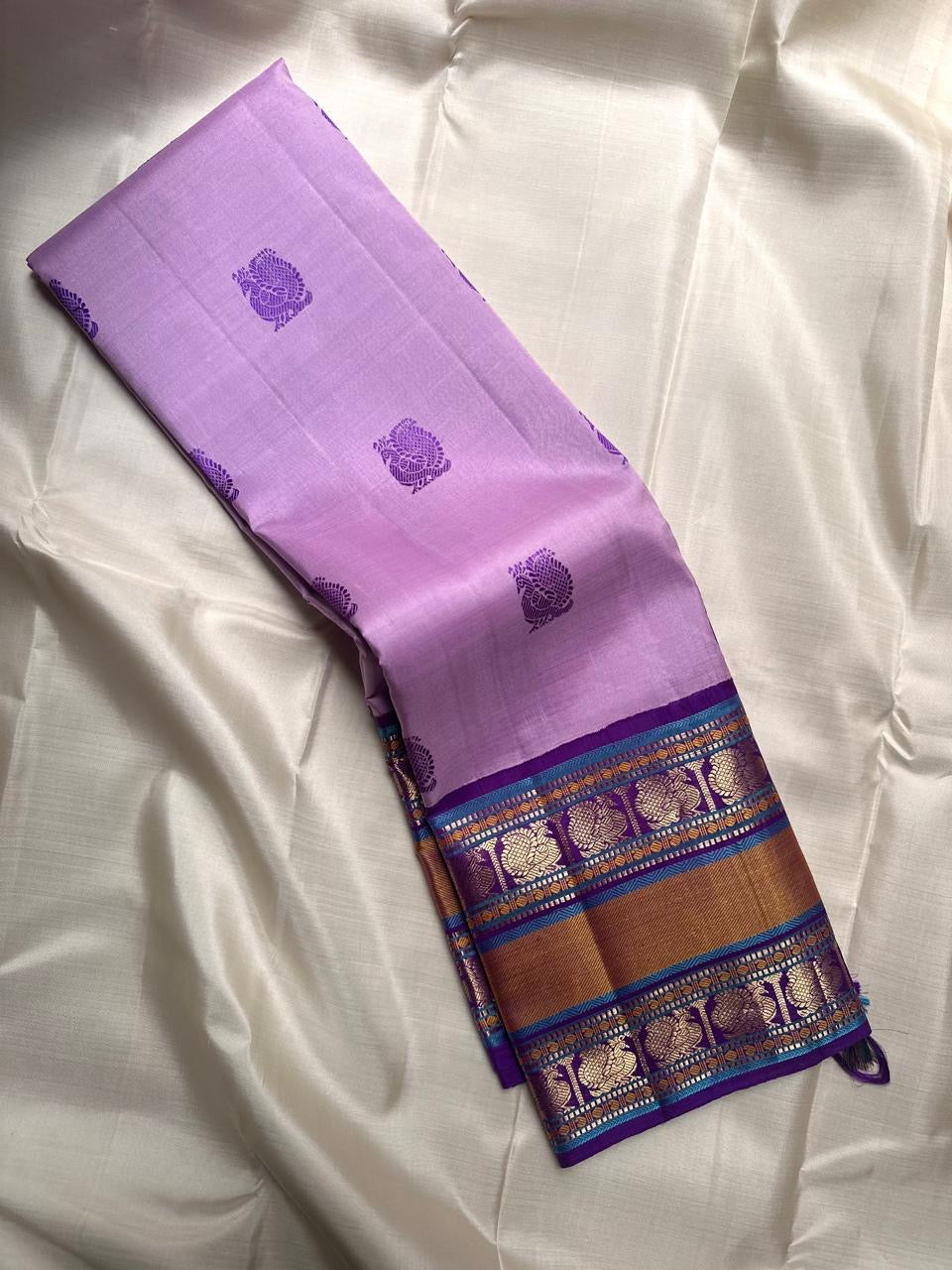 Lavender Kanjivaram silk saree with royal purple Varisaipet peacock motif border, full view