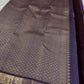 Folded lavender Kanjivaram pure silk saree showing Zari Kattam grid body and deep purple border