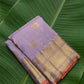 Kanchipuram silk saree in lavender mist with peach orange selvedge antique gold border border Zari Kattam weave folded view