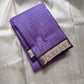 Folded lavender muthu kattam Kanchipuram silk saree with zari woven border on ivory fabric