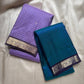 Two folded sarees stacked, lavender muthu kattam with zari woven border beside teal saree