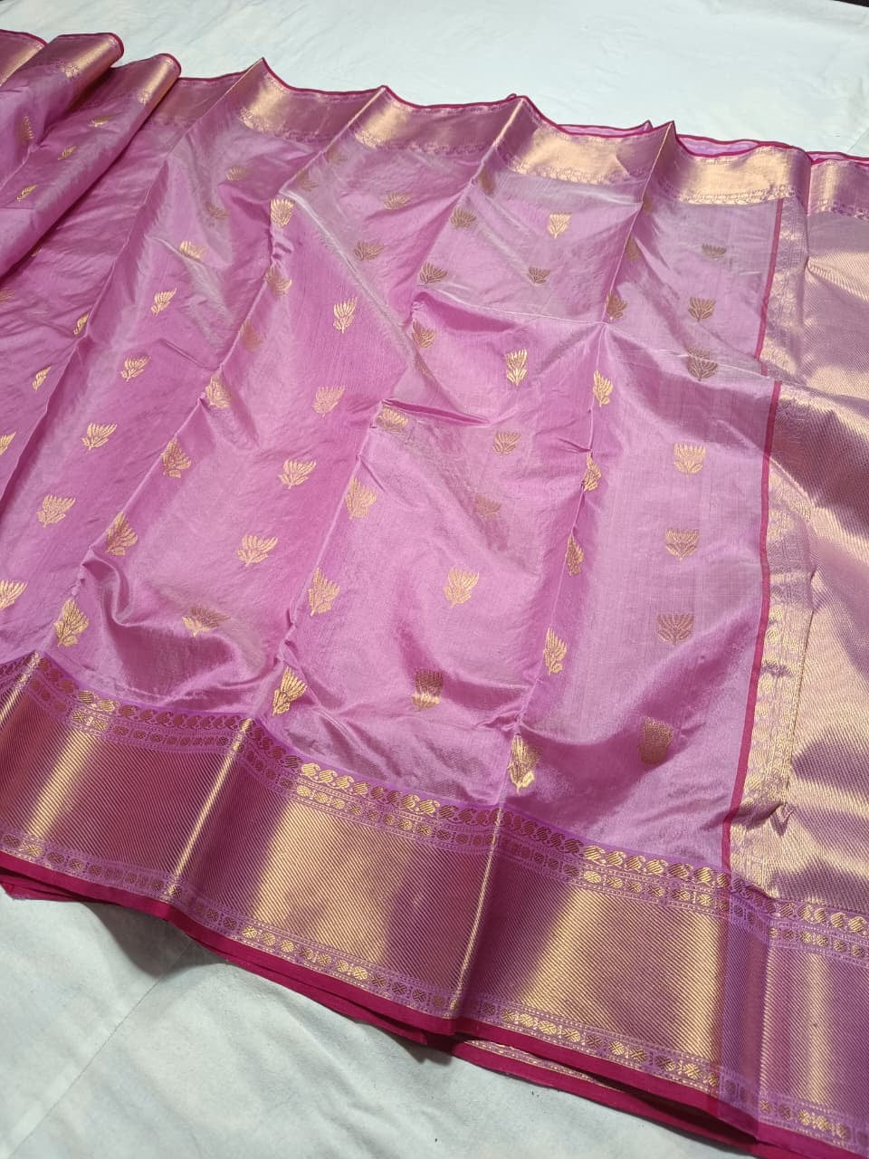 Lavender Pink handloom Chanderi silk saree opened to show gold buttas, ornamental border and luminous woven pallu