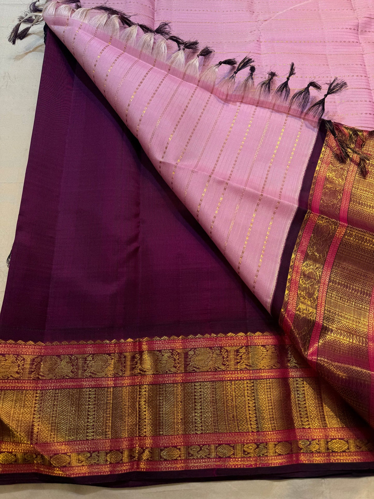 Lavender Pink Kanchipuram silk saree with continuous Veldhari zari lines and Deep Aubergine border.
