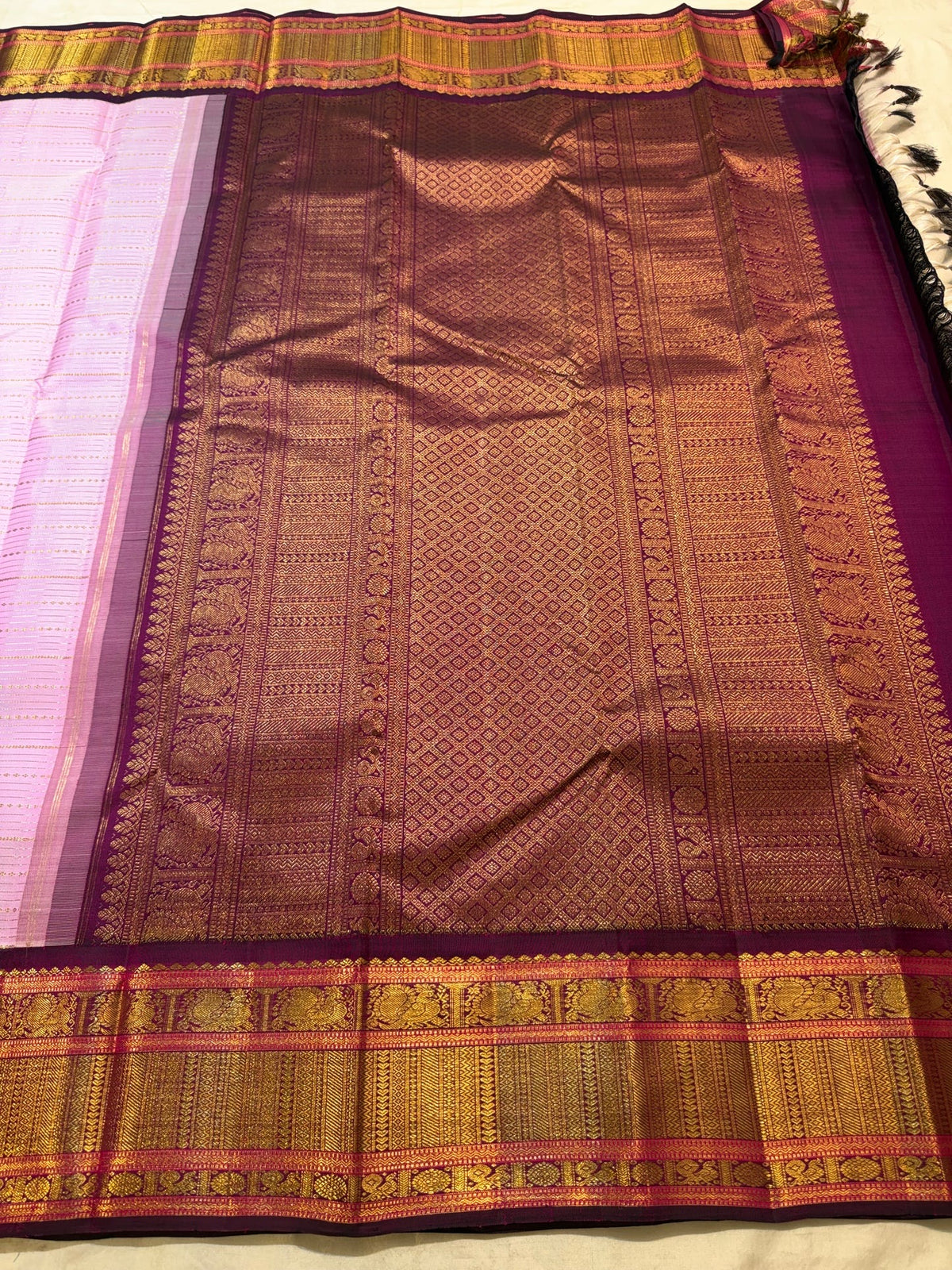 Close view of delicate warm-gold Veldhari stripes across Dusty Lavender Pink pure silk.